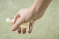 Closeup hand holding a bottle of cologne