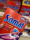 Closeup of hand holding box with Somat dishwasher tabs in front of shelf in german supermarket Royalty Free Stock Photo