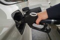 Closeup of a hand holding fuel pump and refilling car at petrol station Royalty Free Stock Photo