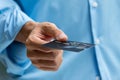 Closeup of hand holding and giving credit card for payment Royalty Free Stock Photo