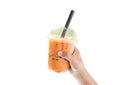 Closeup hand holding glass of ice thai tea on white background Royalty Free Stock Photo