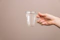 Closeup hand holding a glass of water. body hydration