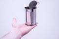 Closeup of a hand holding an opened and empty tin can in front of a white background Royalty Free Stock Photo
