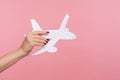 Closeup hand holding paper plane, advertise of airline service, plane landing or departure, concept of travelling Royalty Free Stock Photo