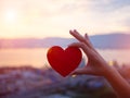 Closeup hand holding red heart during sunset background. Happy, Royalty Free Stock Photo