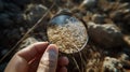 Closeup of a hand holding a sample of grain with a magnifying gl highlighting the high level of cleanliness and quality