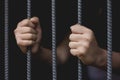 Closeup of a hand holding a steel cage in prison, prisoner concept, Hope to be free. Royalty Free Stock Photo