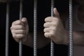 Closeup of a hand holding a steel cage in prison, prisoner concept, Hope to be free. Royalty Free Stock Photo