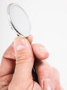 Closeup of hand holding a stethoscope towards bright Royalty Free Stock Photo