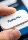 Closeup Hand Holding White Subscribe Button Blue Text Royalty Free Stock Photo