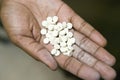 A closeup of a hand holds AIDS pills at the Pepo La Tumaini Jangwani, HIV/AIDS Community Rehabilitation Program, Orphanage & Royalty Free Stock Photo