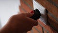 Closeup of hand inserting black plug into white socket Royalty Free Stock Photo