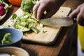 Closeup of hand with knife cutting cauliflower Royalty Free Stock Photo