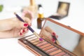 Closeup of hand makeup artist testing different eyeshadows