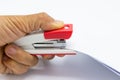 hand man holding pink stapler and paper document Royalty Free Stock Photo