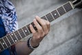 hand of man playing electric guitar in outdoor Royalty Free Stock Photo