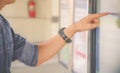 Closeup hand of a man pointing finger to screen large display of a orders food in the touch screen terminal or in the electronic