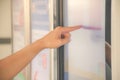 Closeup hand of a man pointing finger to screen large display of a orders food in the touch screen terminal or in the electronic