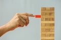 Closeup hand man take one block on The tower from wooden blocks, Royalty Free Stock Photo