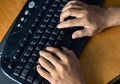 closeup of hand man typing on keyboard