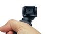 Closeup hand manoeuvring and control little ccompact amera with gimbal on white background