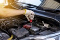 Hand mechanic engineer fixing car battery at garage,concept car maintenance