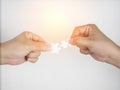 Closeup hand of men connecting jigsaw puzzle with light effect Royalty Free Stock Photo