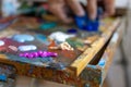 Closeup of hand mixing paint on palette at workshop Royalty Free Stock Photo