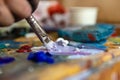 Closeup of hand mixing paint on palette at workshop Royalty Free Stock Photo