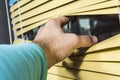 Closeup of hand opening venetian blinds. Royalty Free Stock Photo