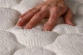 closeup of a hand pressing down on an orthopedic pillow, highlighting firmness Royalty Free Stock Photo