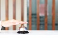 Closeup of hand ringing silver bell on hotel reception service desk, vintage bell with customer hand, check in hotel service on Royalty Free Stock Photo