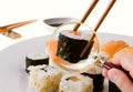 Hand Scrutinizing Sushi Served In Plate Through Magnifying Glass Royalty Free Stock Photo