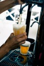 Closeup of hand serving beer in glass using tap. Bartender pouring beer while standing at bar counter.  Barman hand at beer tap Royalty Free Stock Photo