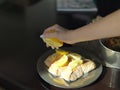 Hand squeezing lemon on grilled salmon Royalty Free Stock Photo