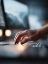 Closeup of hand typing on keyboard. Soft, atmospheric lighting. Concept creativity, technology, focus, writing, and remote work. Royalty Free Stock Photo