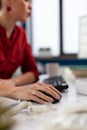 Closeup of hand using wireless computer mouse in startup office. Royalty Free Stock Photo