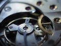 Closeup of hand watch mechanism gears under the lights