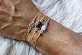 Closeup of a hand wearing tiny elegant mineral stone bracelets