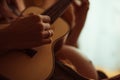 Closeup of hand with the wedding ring of a woman playing ukulele Royalty Free Stock Photo