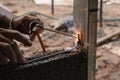 closeup hand welding metal in construction site