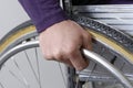 Closeup of hand an wheel of wheelchair