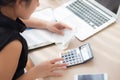 Closeup hand woman calculating expenses household and writing notebook on desk, girl checking bill and stress and note Royalty Free Stock Photo