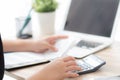 Closeup hand woman calculating expenses household and writing notebook on desk, girl checking bill and stress and note Royalty Free Stock Photo