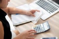 Closeup hand woman calculating expenses household and writing notebook on desk, girl checking bill and stress and note Royalty Free Stock Photo