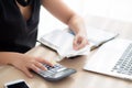 Closeup hand woman calculating expenses household and writing notebook on desk, girl checking bill and stress and note Royalty Free Stock Photo