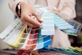 Closeup hand of woman decorator, interior and graphic designer, architect is choosing catalogue colors ral for web Royalty Free Stock Photo