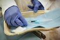 Closeup hand of woman doctor in lab hold syringe