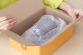 Closeup hand of woman opening parcel box with check product at home female unpack with knife delivery and shipping shipment and