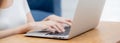 Closeup hand of woman typing keyboard on laptop computer on desk at home, business woman working to internet online. Royalty Free Stock Photo